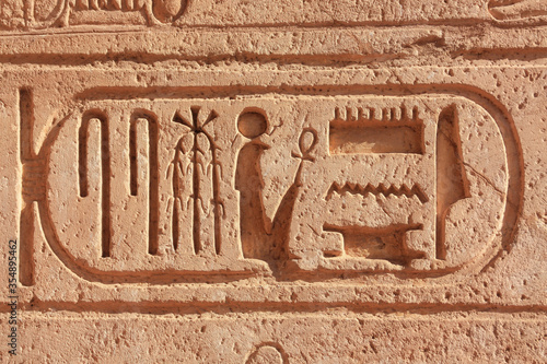 Ancient historical characters encased in a cartouche at a temple in Upper Egypt. It is the famous travel destination Abu Simbel on Lake Nasser.