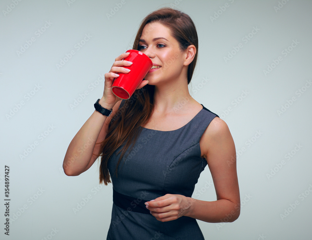 portrait of woman in business dress drinking coffee with red cup. portrait of woman in business dress drinking coffee with red cup.