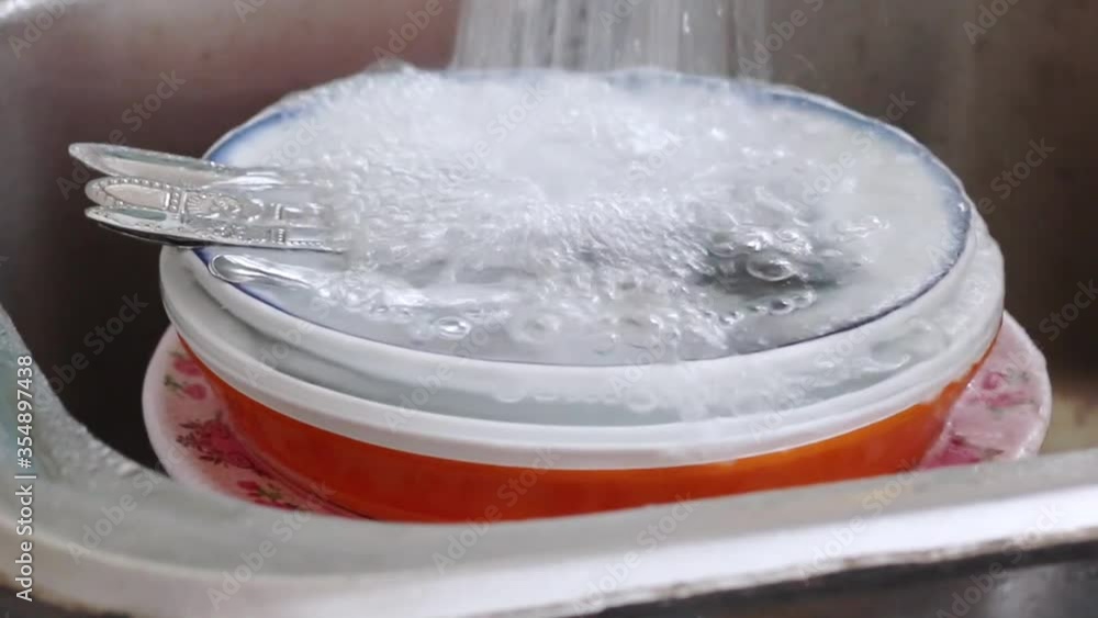 Washing dirty dishes. Washing dirty dishes.