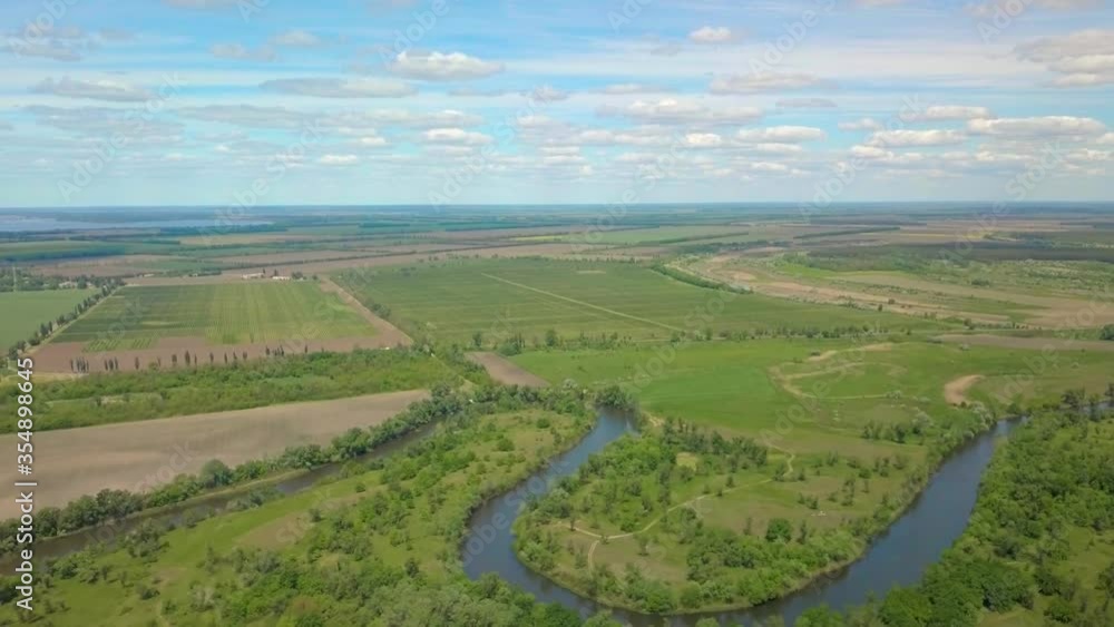 Flight over green meadow, forest and river in spring. Beautiful landscape and nature. Aerial view. Ukraine. 4K Flight over green meadow, forest and river in spring. Beautiful landscape and nature. Aerial view. Ukraine. 4K
