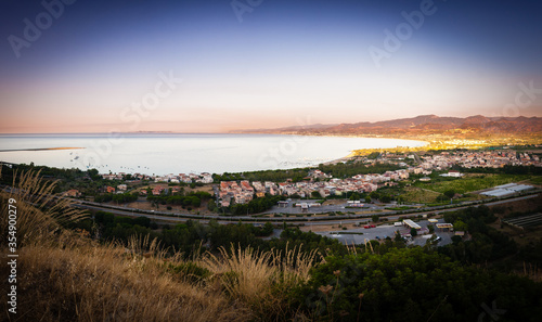 Beautiful panoramic view at sunset of the town of Oliveri in the province of Messina.