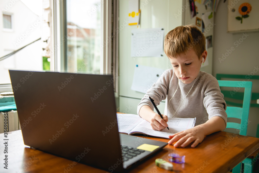 Young boy learning from home, online schooling Young boy learning from home, online schooling