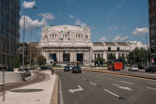 Cars and people near Milano Centrale railway station in Milan, Italy.