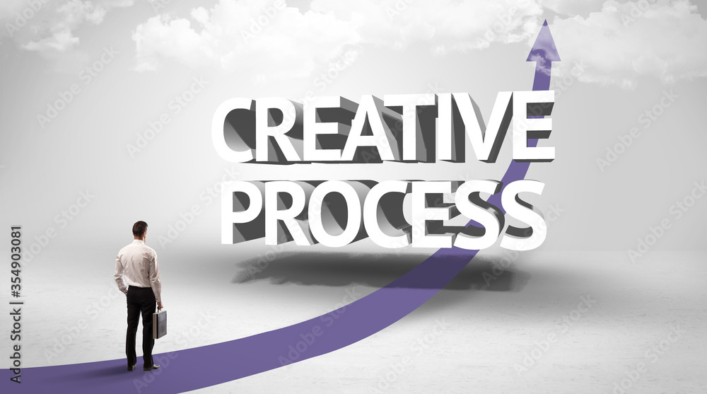 Rear view of a businessman standing in front of CREATIVE PROCESS inscription, successful business concept Rear view of a businessman standing in front of CREATIVE PROCESS inscription, successful business concept