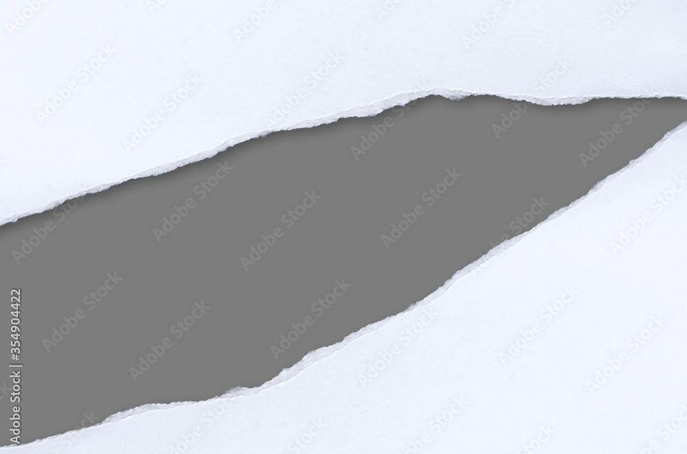 White ripped note paper, paper different shapes scraps isolated on gray background. with clipping path. White ripped note paper, paper different shapes scraps isolated on gray background. with clipping path.