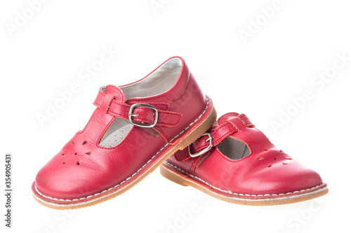 Red children leather shoes for girls isolated on white background