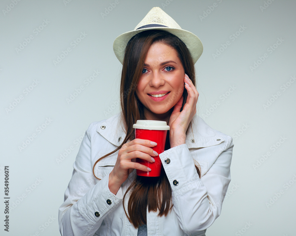 Smiling woman touching face holding red coffee mug. Smiling woman touching face holding red coffee mug.
