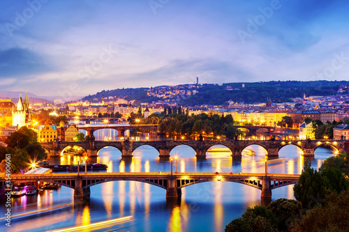 Evening cityscape view of bridges on Vltava in Prague, Czech Republic at colorful twilight sunset.