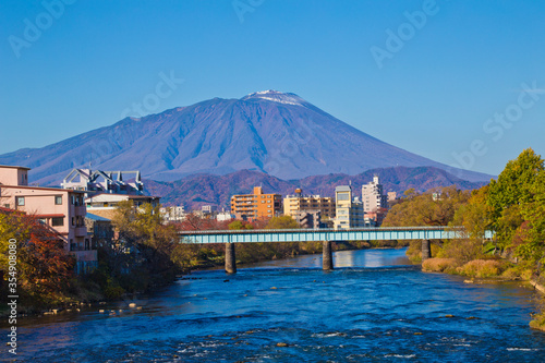 
Mount Iwate scene with buildings and promenade at Katakami river in  Morioka city, Iwate prefecture, Tohoku, Japan. photo