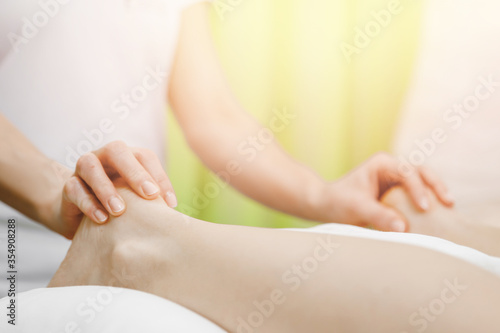 Foot and heel legs massage of young women beauty spa