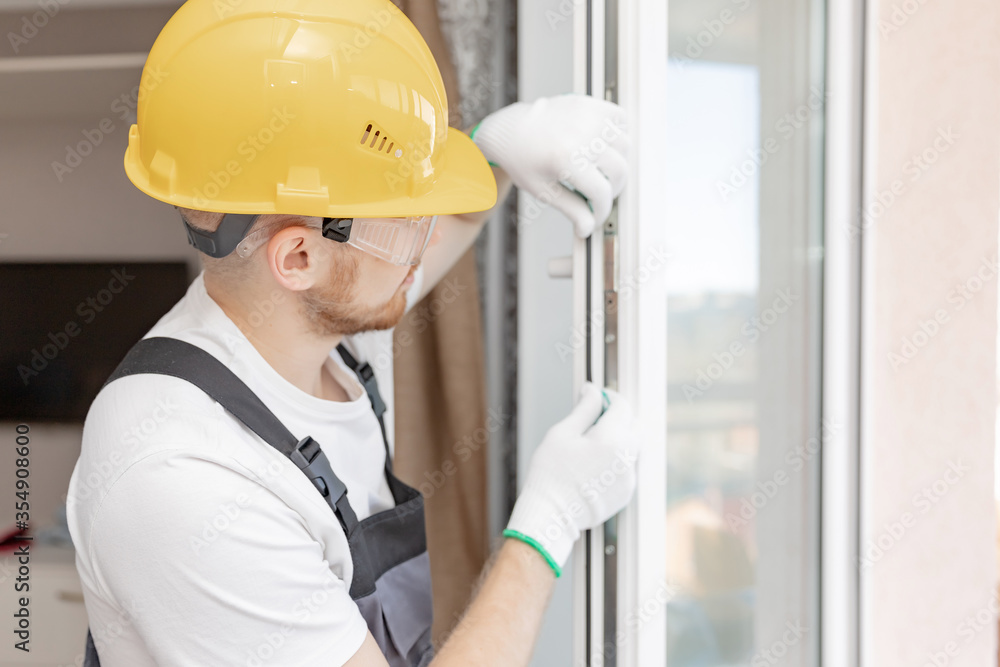 Worker in installing rubber seals on plastic upvc window Worker in installing rubber seals on plastic upvc window