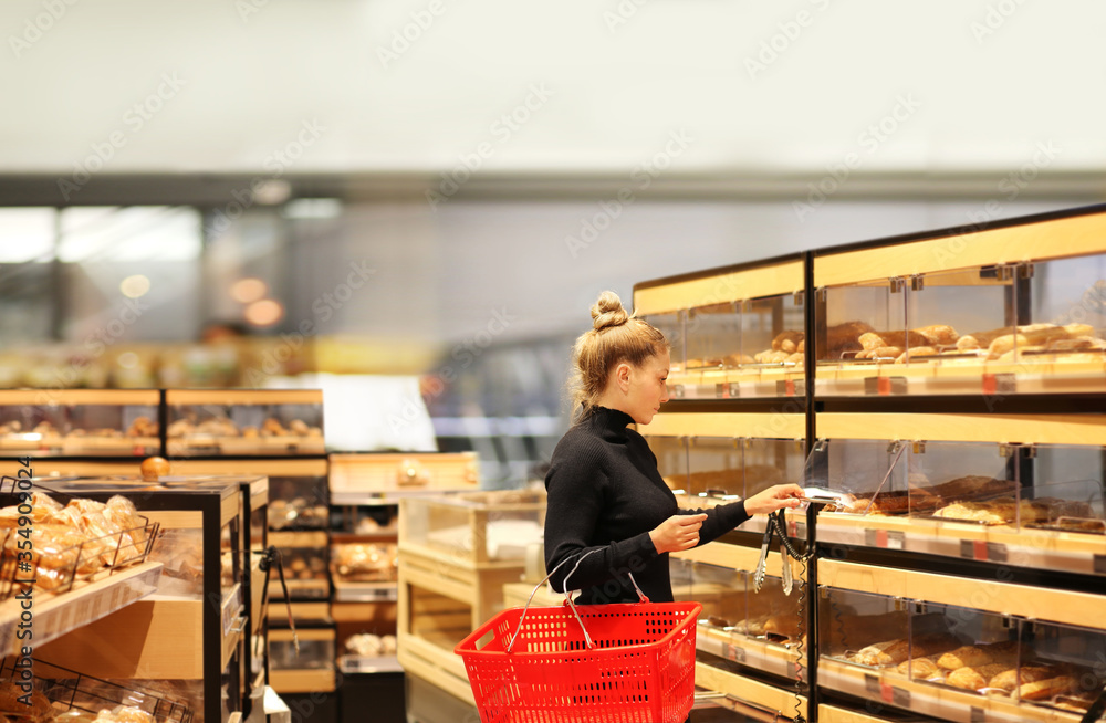 Woman choosing bread from a supermarket Woman choosing bread from a supermarket