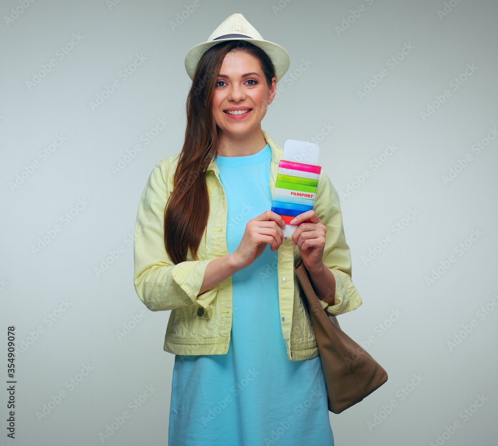 Smiling woman traveler dressed green jacket holding passport and hand bag. Smiling woman traveler dressed green jacket holding passport and hand bag.