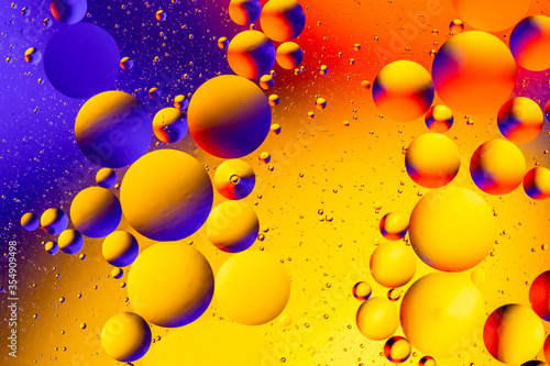 Abstract colorful background with oil on water surface. Oil drops in water abstract psychedelic. Space and universe planets styled psychedelic abstract image