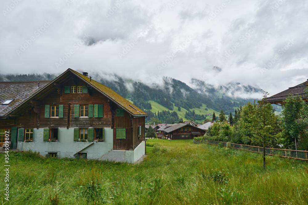 Traditional wooden houses of Swiss Alps. Taken in Mürren, above Lauterbrunnen Valley, Switzerland                        