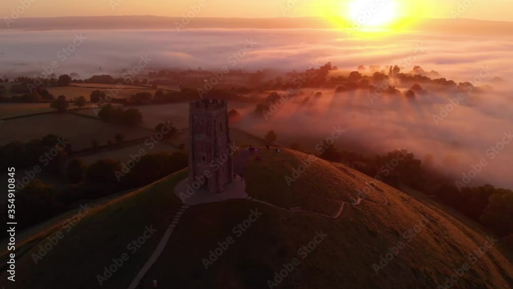 Fly-by shot of the early morning sunrise at Glastonbury Tor in Somerset. Fly-by shot of the early morning sunrise at Glastonbury Tor in Somerset.
