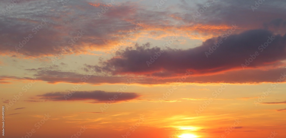 Beautiful panoramic view on orange burgundy sunset in the sky, natural background