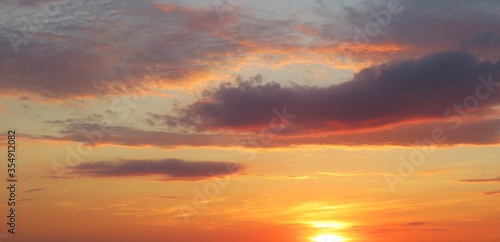 Beautiful panoramic view on orange burgundy sunset in the sky, natural background © natalya2015