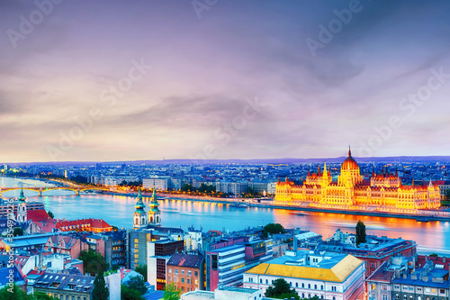 Budapest panorama with parliament and bridge during blue hour sunset.