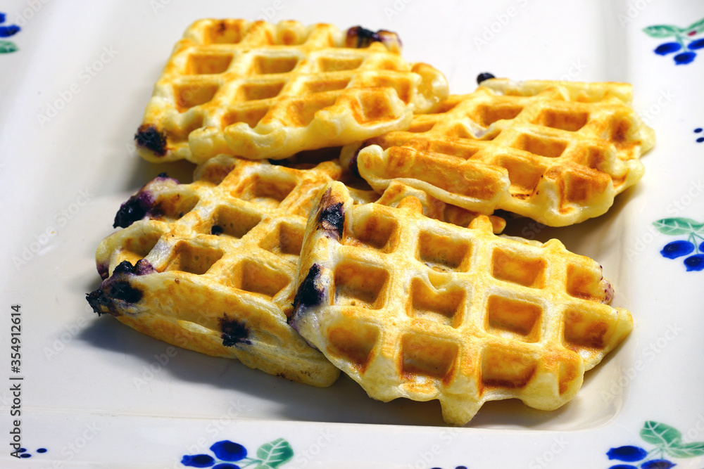 Plate of freshly baked blueberry yeasted waffles for breakfast Plate of freshly baked blueberry yeasted waffles for breakfast