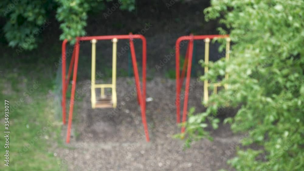 selective focus on drops of rain on background of children's Playground on the street selective focus on drops of rain on background of children's Playground on the street