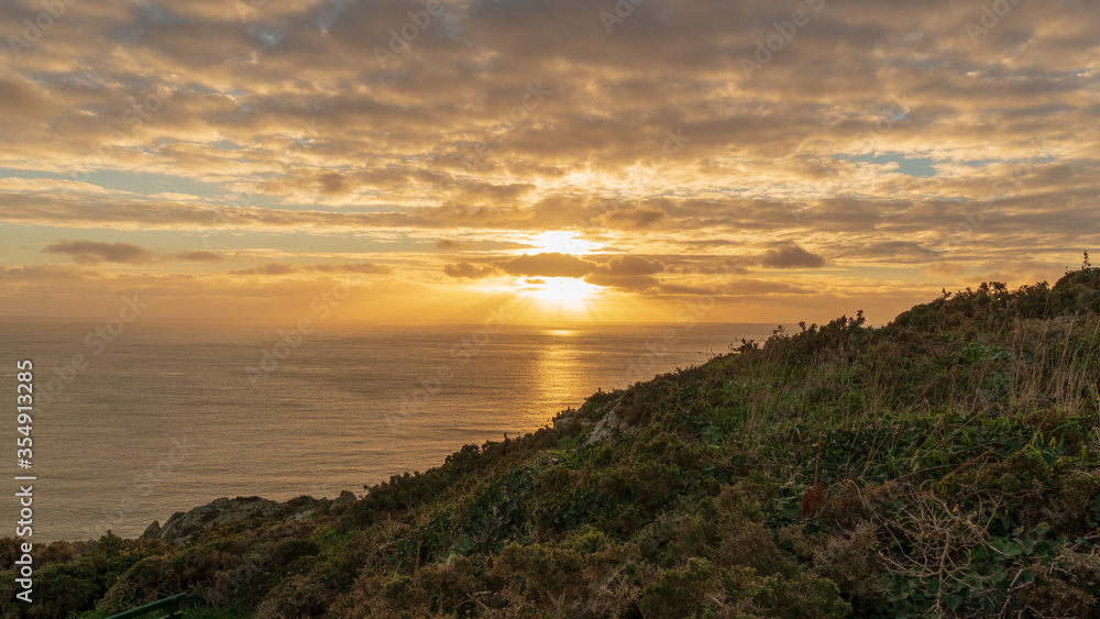 sunset over the sea, view from the cliffs in Guernsey sunset over the sea, view from the cliffs in Guernsey