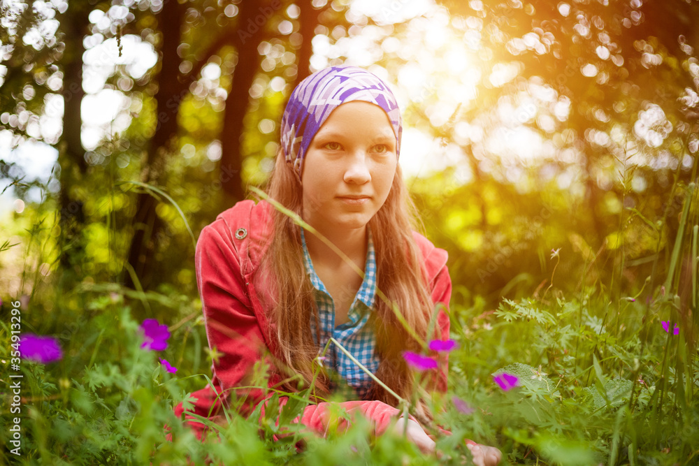 Cute girl lying in the grass with flowers Cute girl lying in the grass with flowers