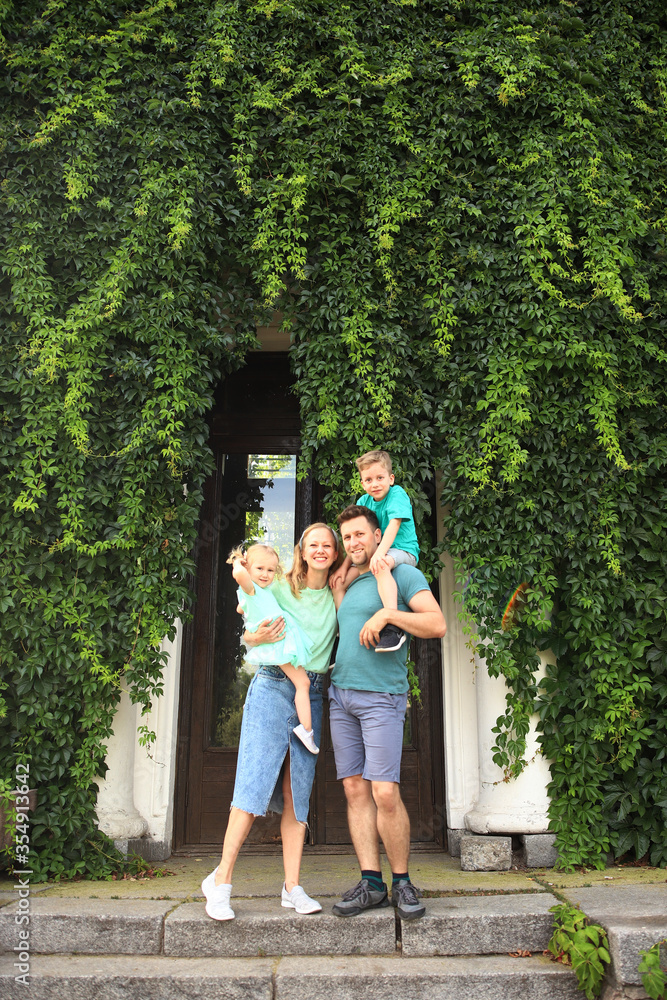Fototapeta premium Happy loving family with two children, son and daughter playing and hugging. Family walk. Happy Mothers day.