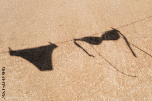 Obraz na plátne bikini hanging on a clothes line on the beach