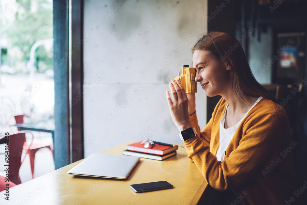 Young woman updating playlist on media application Young woman updating playlist on media application