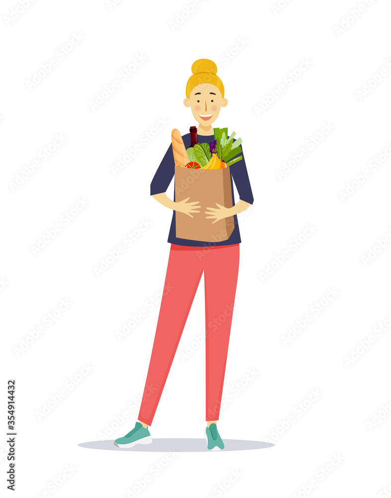 Shopping concept. Happy young adult woman standing and holding paper bag with grocery products Shopping concept. Happy young adult woman standing and holding paper bag with grocery products