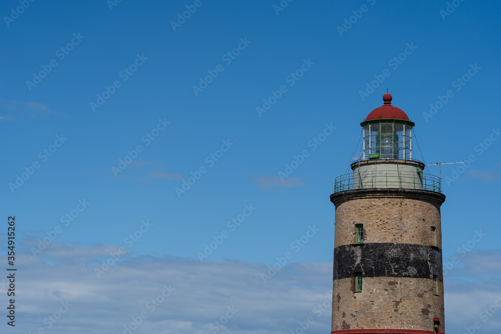 Lighthouse in Falsterbo, Sweden, built 1795. Selective focus. Photo taken in June 2020. Lighthouse in Falsterbo, Sweden, built 1795. Selective focus. Photo taken in June 2020.