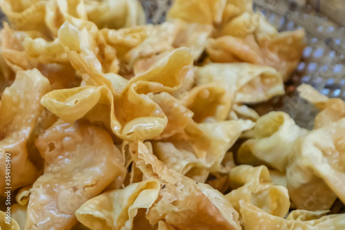 Pangsit Goreng or fried Wonton or fried dumpling crispy. Filled with chicken or shrimp and served with chilli sauce.