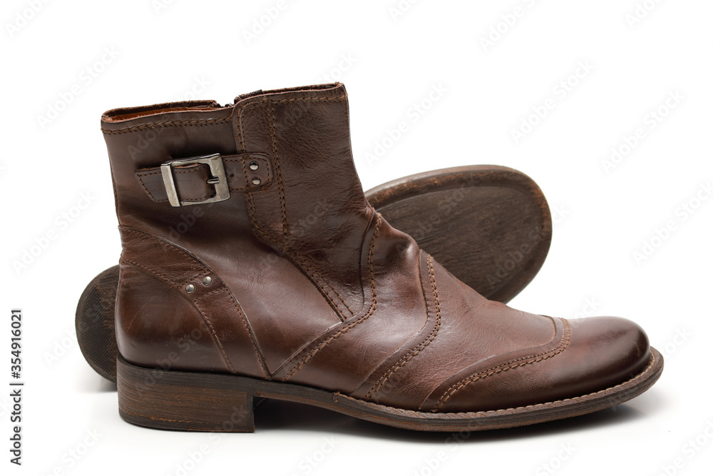 Two brown shoes with untied laces on a white isolated background Two brown shoes with untied laces on a white isolated background