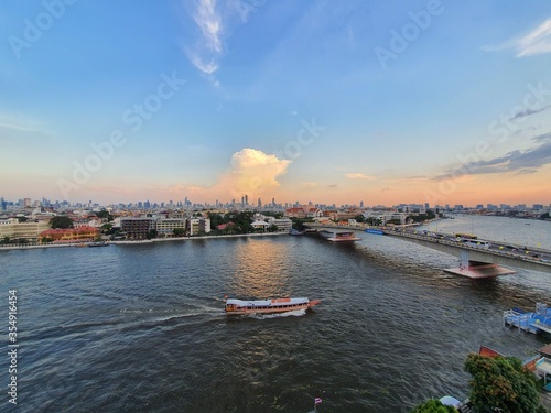 The boat is running in Chaopraya river with blue sky in Thailand