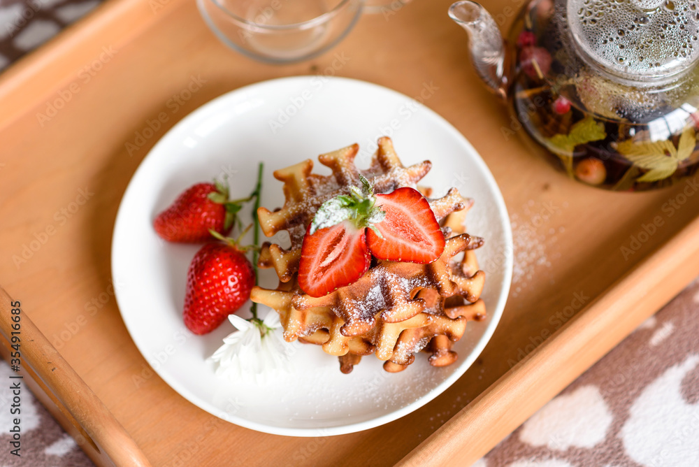 Delicious fresh baked belgian waffles with berries and fruit Delicious fresh baked belgian waffles with berries and fruit