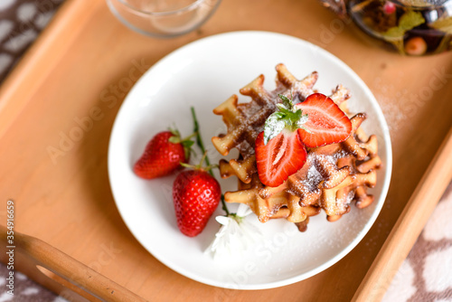 Delicious fresh baked belgian waffles with berries and fruit