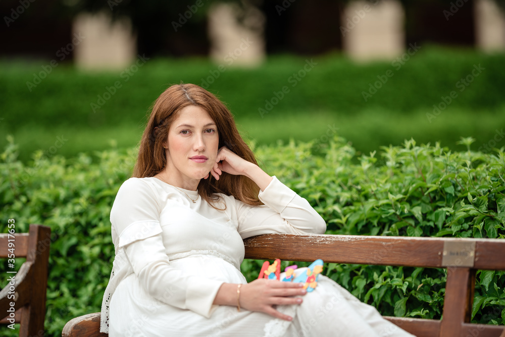 Pregnant woman holding a letter from plastic. Pregnant woman holding a letter from plastic.
