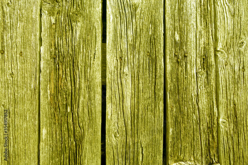 Weathered rustic wood planks with nails. Yellow toned