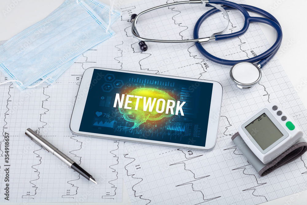 Tablet pc and medical tools with NETWORK inscription, social distancing concept Tablet pc and medical tools with NETWORK inscription, social distancing concept