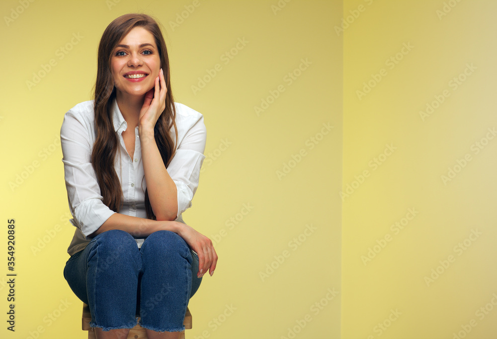 Young woman dressed casual white shirt sitting on stool. Young woman dressed casual white shirt sitting on stool.