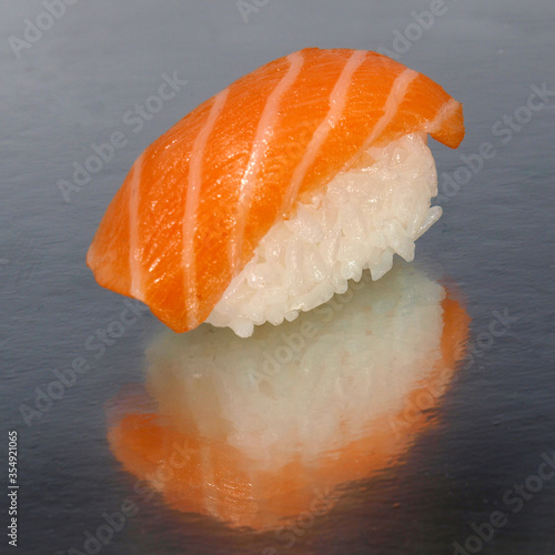 Salmon sushi on a shiny surface. Japanese kitchen