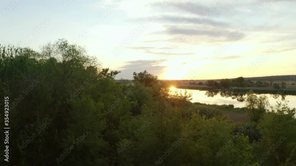 Amazing view of river and beautiful forest at sunset. Drone video recording Amazing view of river and beautiful forest at sunset. Drone video recording