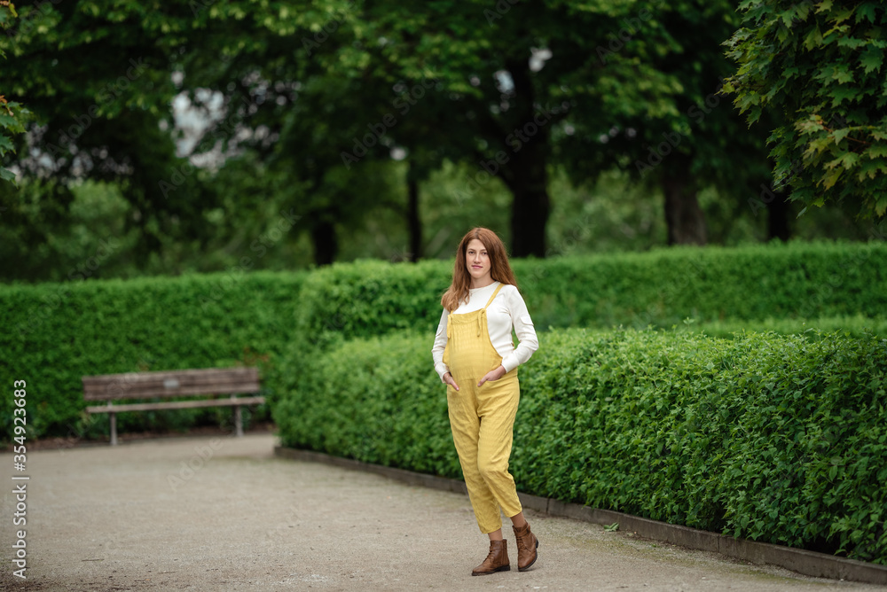 Beautiful pregnant girl walking in the Park.
