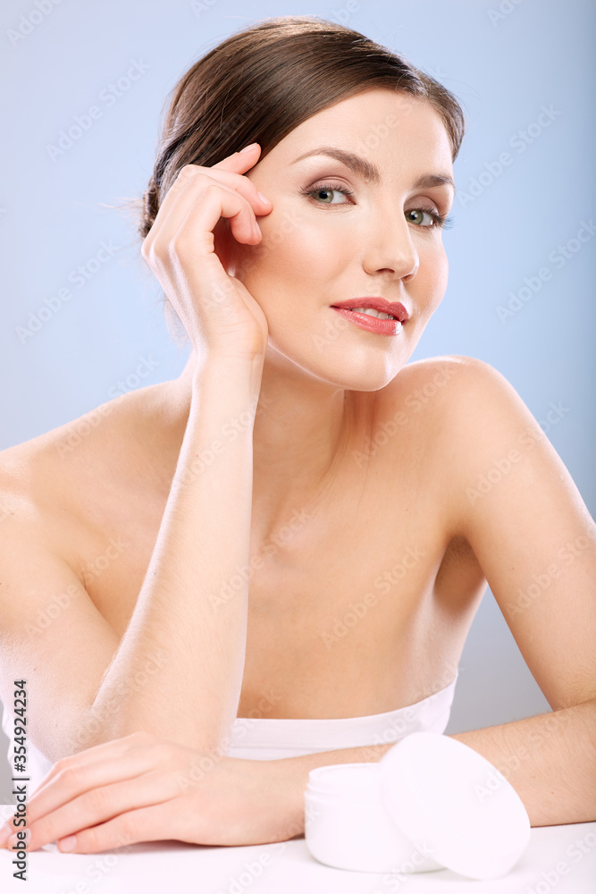 portrait of woman touching face.