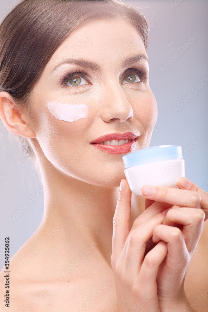 close up beauty portrait of smiling woman holding jar cream. close up beauty portrait of smiling woman holding jar cream.