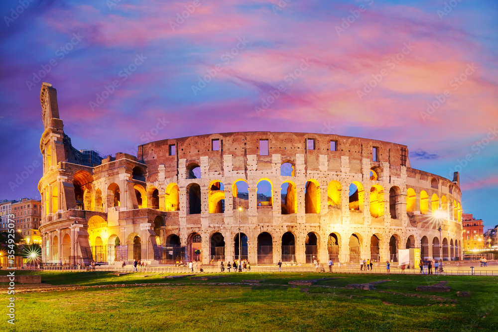 The Colosseum in Rome, Italy at colorful sunset twilight. The world famous colosseum landmark in Rome.
