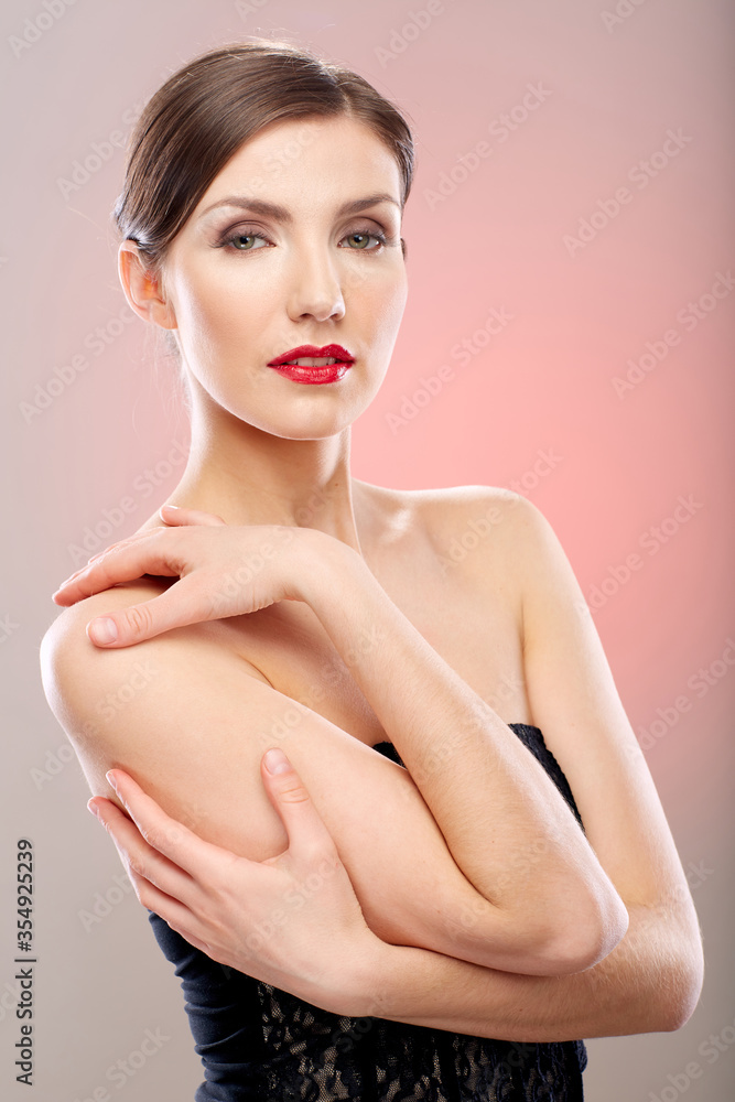 Fototapeta premium Beautiful woman in black dress on pink background