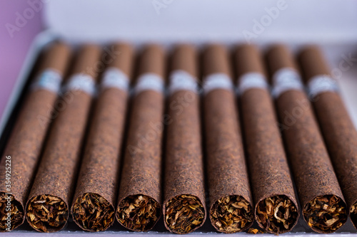 brown cigarettes with a filter in a cigarette case