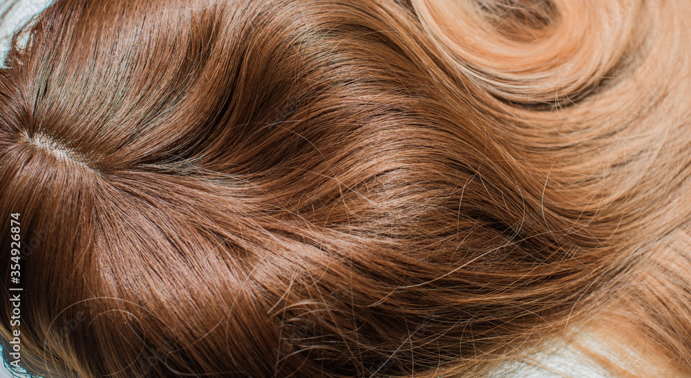 Wigs synthetic and natural hair. Light blown and blonde ombre hair. Womens beauty concept Wigs synthetic and natural hair. Light blown and blonde ombre hair. Womens beauty concept